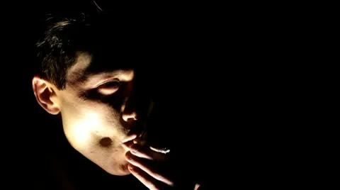 Man in shadow smoking cigarette Stockbeeldmateriaal 10700129
