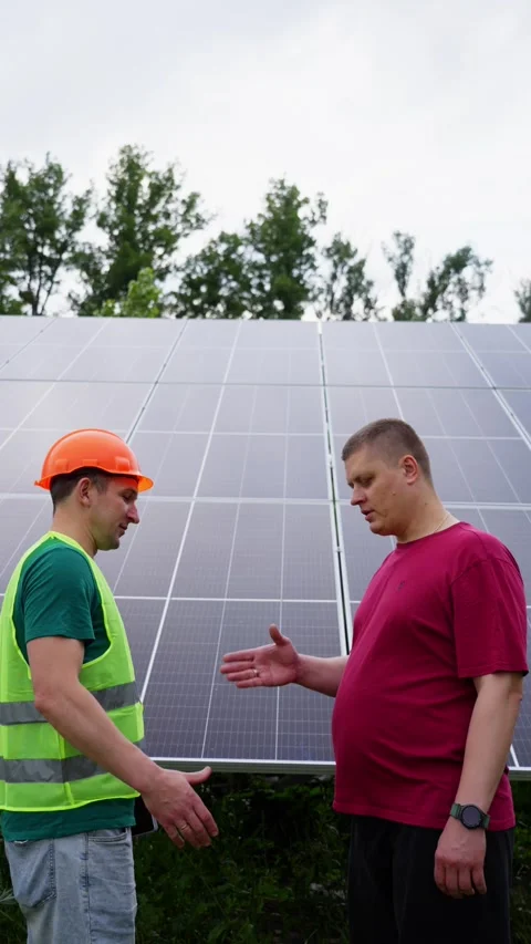 A man shakes hands with an engineer who was installing solar panels. Stock-Footage 313535063