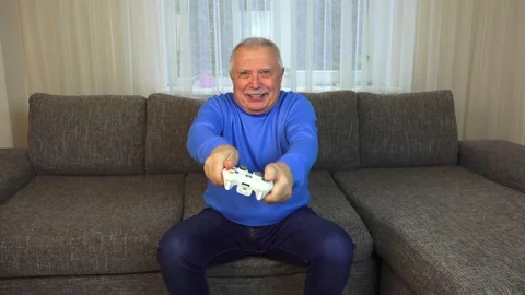 Man shakes white console and plays interesting video game Stock Footage 108605048