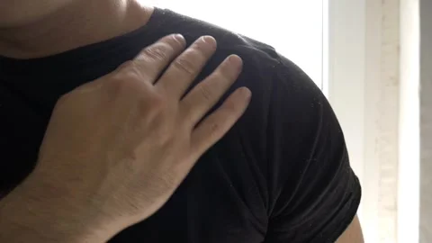 Man Shaking Dandruff Off T-Shirt in Slow Motion – Close-Up View Stock Footage 306446053