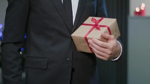 Man Shaking Hands and Holding a Christmas Gift Stock Footage 85869302