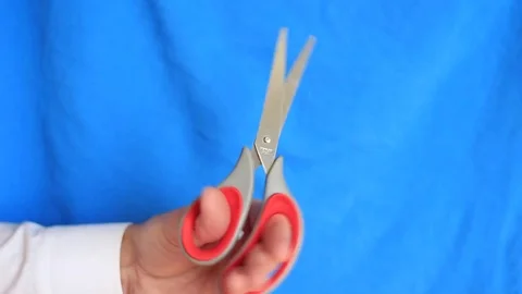 Man shaking with scissors on the blue background Stock Footage 70751242