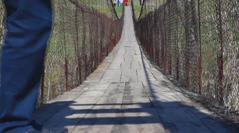 A man shaking suspension bridge Stock Footage 23075212