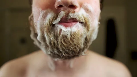 Man with Shampoo filled beard blows bubbles away from mouth Stock Footage 139992372