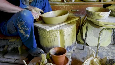 A man shapes a clay dish. Stock Footage 168949217