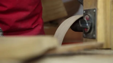 Man shaping the side of a guitar that is under construction Stock Footage 60427352