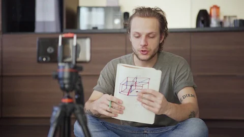 Man sharing ideas during video call at home Stock Footage 128574140