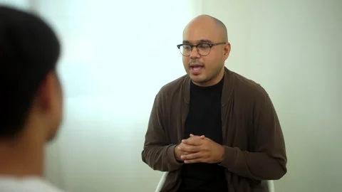 Man sharing problem in support group and talking together with psychologist. Stock Footage 245895931