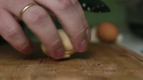 A man with a sharp knife cuts fresh mushroom champignon into thin slices Stock Footage 131191465