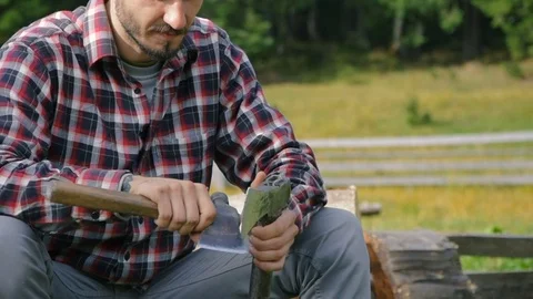 Man sharpen an axe Stock Footage 82700720