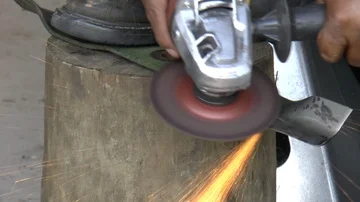 Man Sharpening Blade Using Angle Grinder Stock Footage 85570370