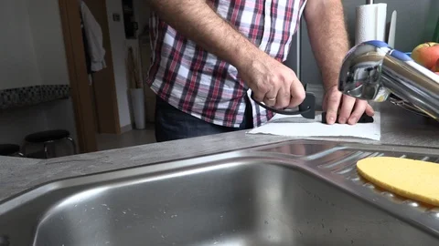 The man is sharpening a kitchen knife Stock Footage 95552711
