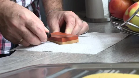 The man is sharpening a kitchen knife Stock Footage 95584799