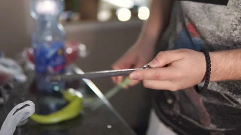 A man is sharpening a knife in the kitchen Stock Footage 263336918
