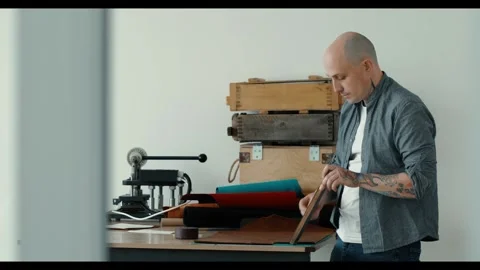 Man sharpening knife for leather cut with special stone tool, craftsman at work 動画素材 298958534
