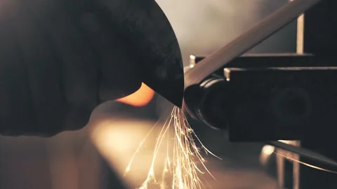 Man sharpening knife with sparks Stock Footage 136034230