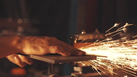 Man sharpening knife with sparks. Work on a sharpening machine. Stock Footage 134790966