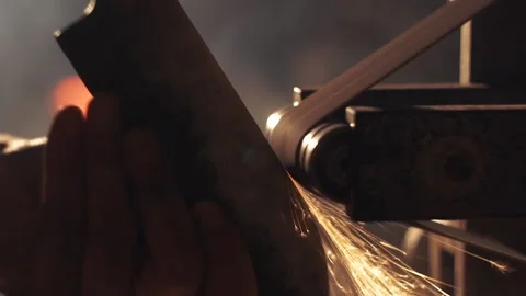 Man sharpening knife with sparks. Work on a sharpening machine. Stock Footage 134793173
