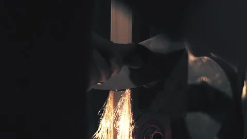Man sharpening knife with sparks. Work on a sharpening machine Stock Footage 135314546