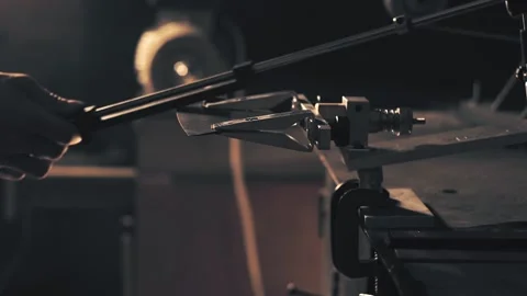 Man sharpening knife. Work on a sharpening machine Stock Footage 135078271