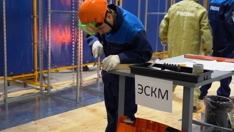 Man sharpening or processing edges of metal tube. Daily work on factory, indoor Stock Footage 126356514