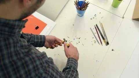Man sharpening pencil with a pencil sharpener 動画素材 71441822