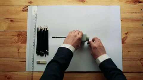 Man sharpening pencil with a pencil sharpener Stock Footage 73779024