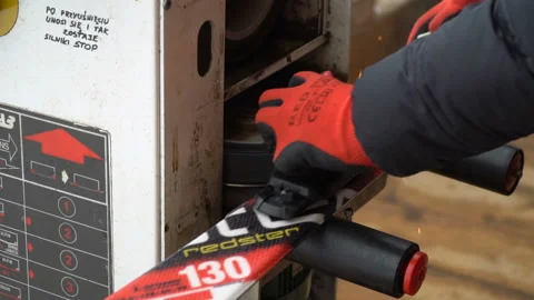 Man sharpening skis for skiing. Professional machine prepare skis Stock Footage 87268635