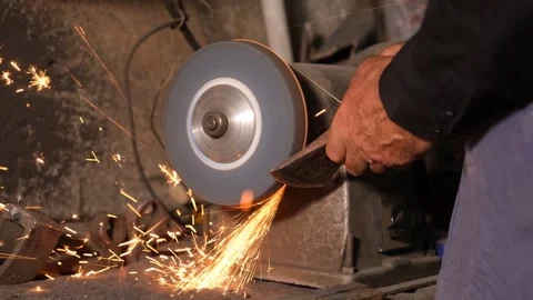 Man Sharpening Tool On Grinding Wheel With Sparks Stock Footage 324567414
