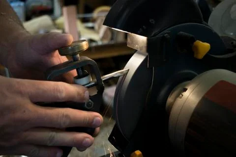 Man sharpening tool. 库存照片