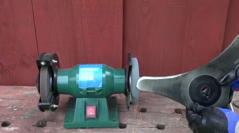 Man sharpening trimmer tool Stock-Footage 58850840