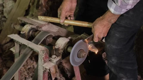 Man sharpens the ax in the workshop Stock Footage 294066079