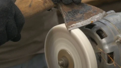 A man sharpens a big ax. Video stock 77865963