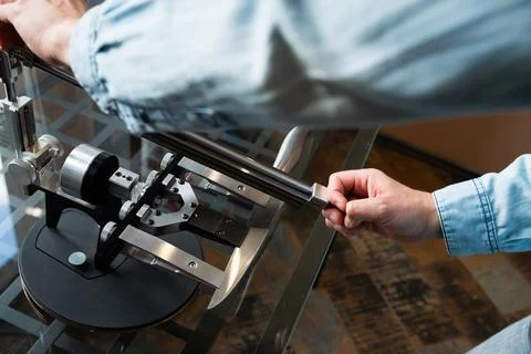 Man sharpens a chef's knife with a sharpening system in the kitchen Stock Photos
