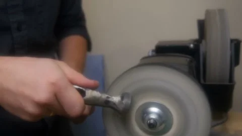Man sharpens a hammer on a machine 스톡 동영상 81419355