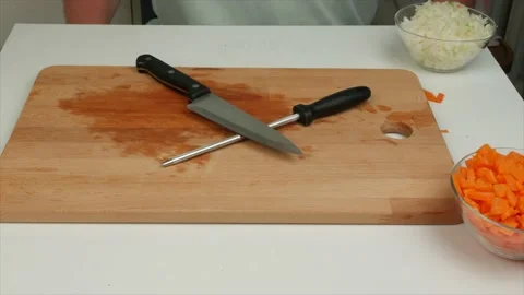 A man sharpens a kitchen knife on honing steel,close-up Stock Footage 133715066