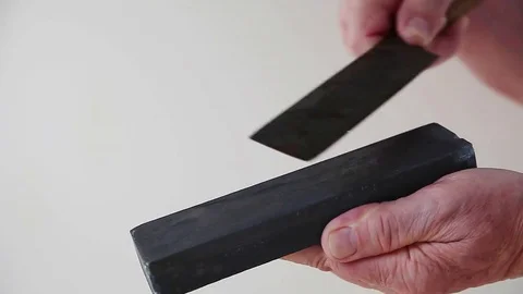 Man sharpens knife Stock Footage 83517403