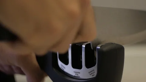 Man sharpens a knife on the sharpener Stock Footage 99566856