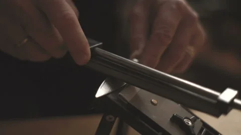 Man sharpens a knife with a sharpener for knives video Stock Footage 85798223