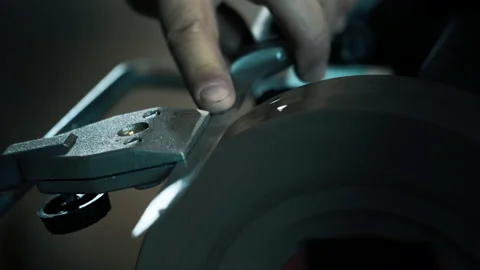 Man sharpens knives on a grinder. Close up hand. wetstone Stock Footage 142156349