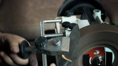 Man sharpens knives on a grinder. Close up hand Stock-Footage 143672397