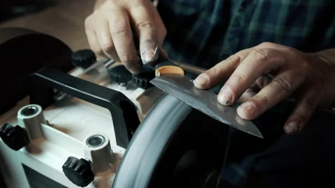 Man sharpens knives on a grinder. Close up hand Stock-Footage 143672814