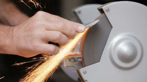 A man sharpens a metal part of the machine Stock Footage 67578094