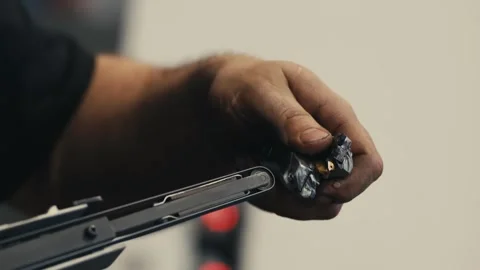 Man sharpens a metalworking drill bit Stock Footage 263425896