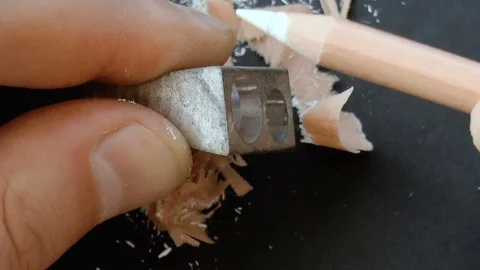 Man sharpens a pencil with a sharpener Stock Footage 78911320