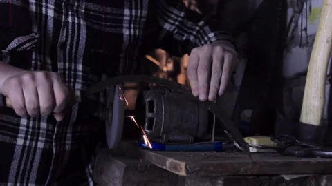 A man sharpens a sickle on a grinder sharpener close-up Stock Footage 137970731