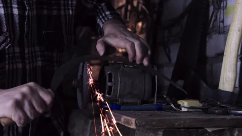 A man sharpens a sickle on a grinder sharpener close-up Stock Footage 140108567