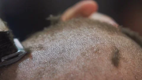 The man shaves the back of the man's head with a trimmer. Stock Footage 143328855