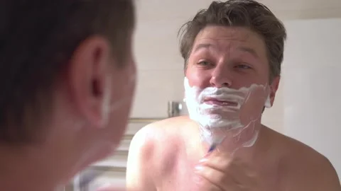 A man shaves in the bathroom. Timelapse Stock Footage 145147691