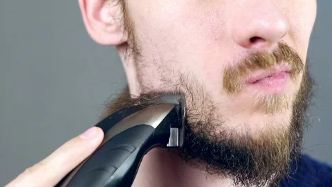 Man shaves beard Stock Footage 104947096